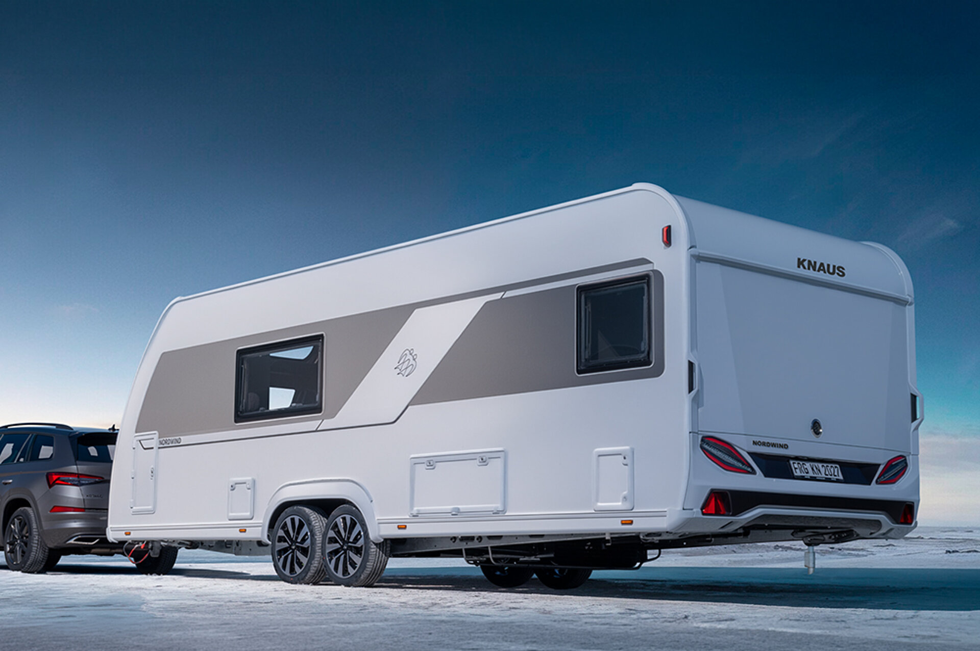 A white caravan seen diagonally from behind.