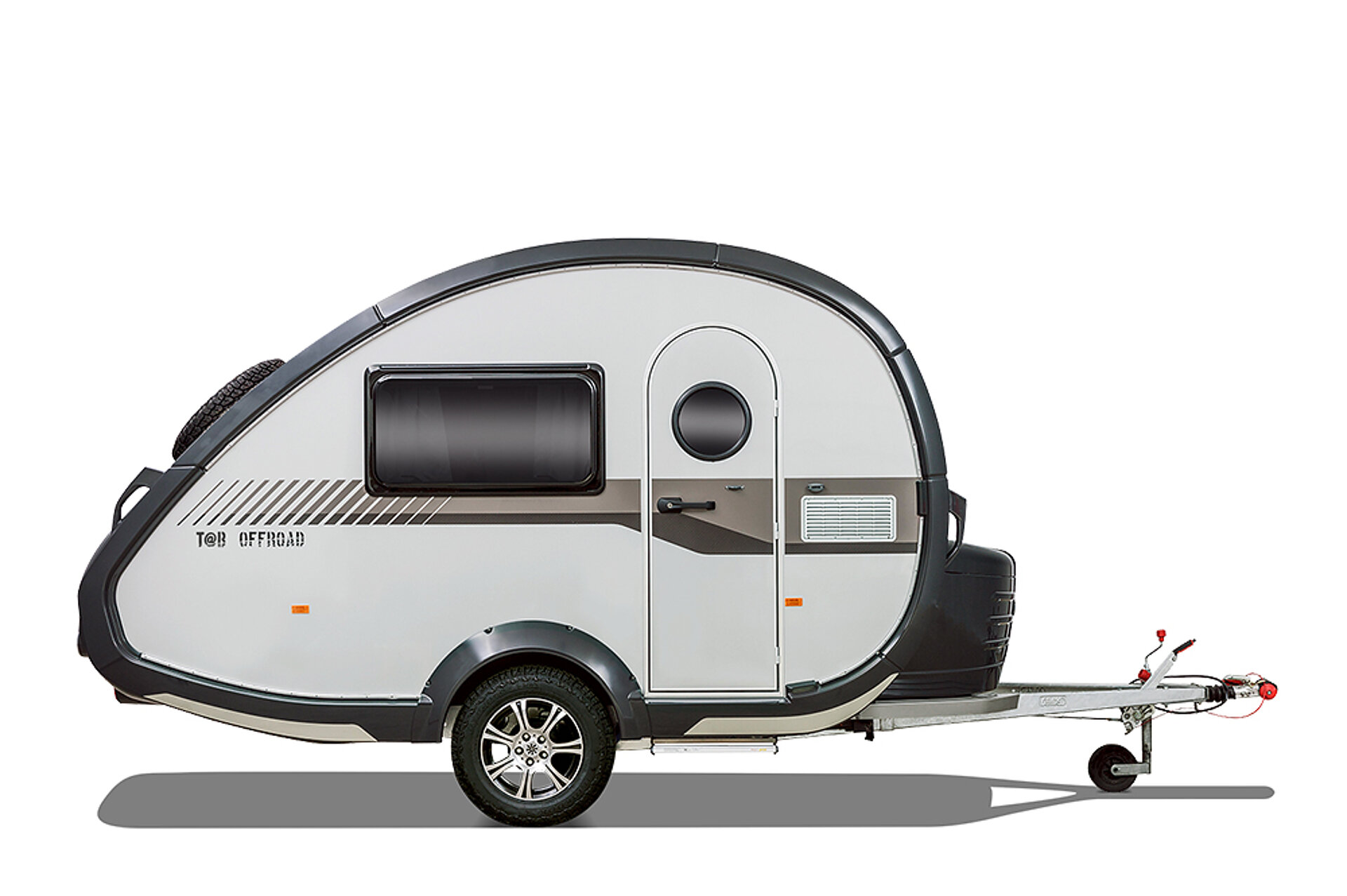 Weißer, kleiner Wohnwagen in runder Form.